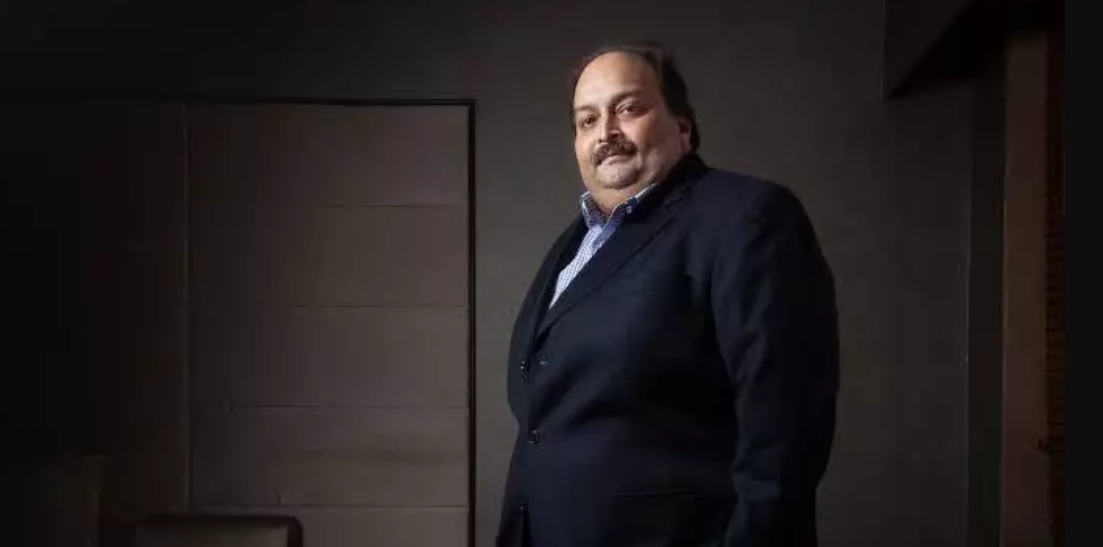 A dramatic digital artwork of Mehul Choksi in a courtroom, surrounded by legal documents and Belgian flags, with a backdrop of Antwerp’s skyline and Indian justice symbols.